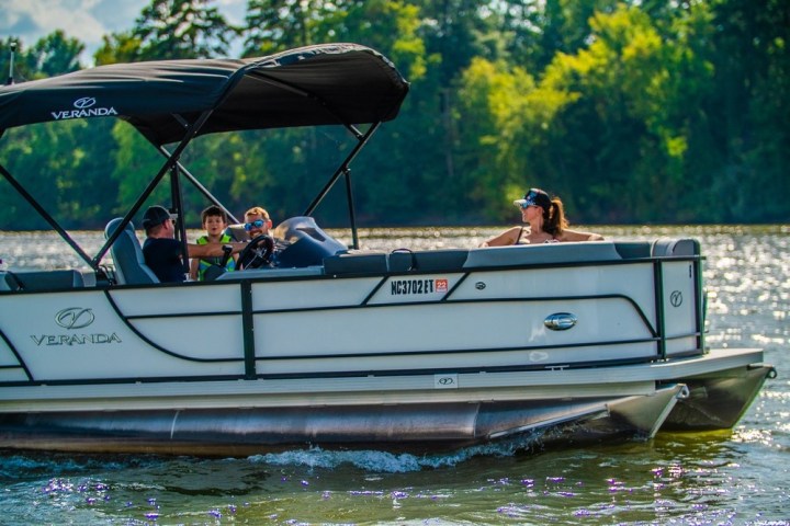 a group of people in a small boat in a body of water