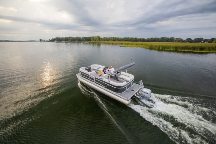 a boat traveling along a river next to a body of water