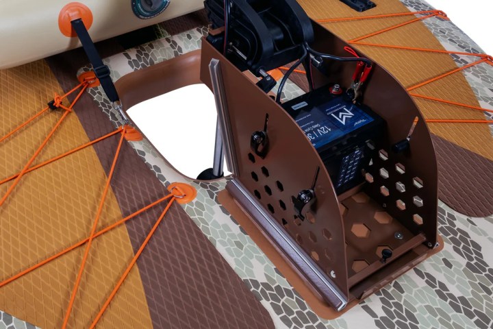 Close-up of a camo-patterned board with mounted motor and battery.